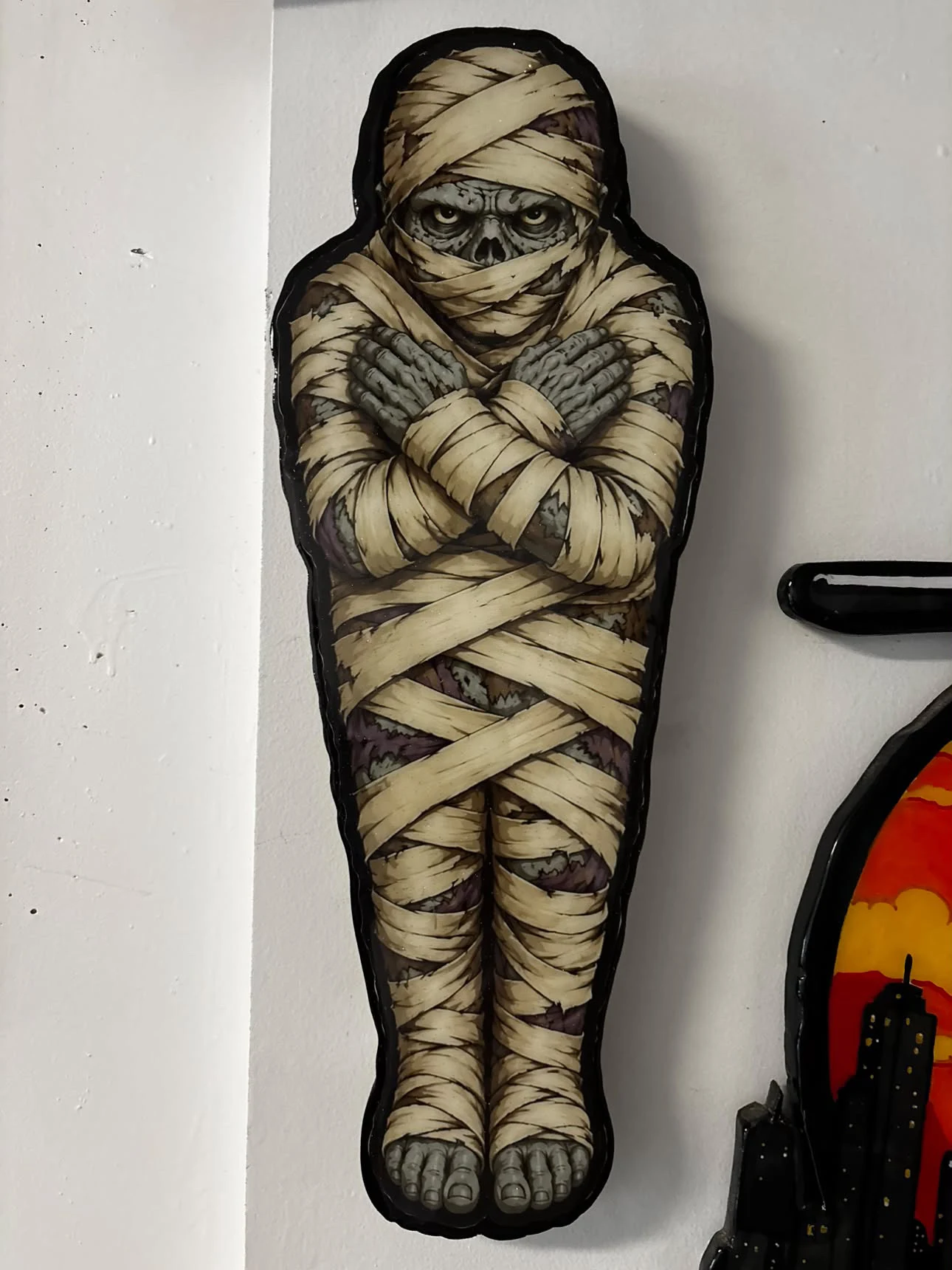 O He Paints studio photograph: Hand-painted mummy figure cut from wood